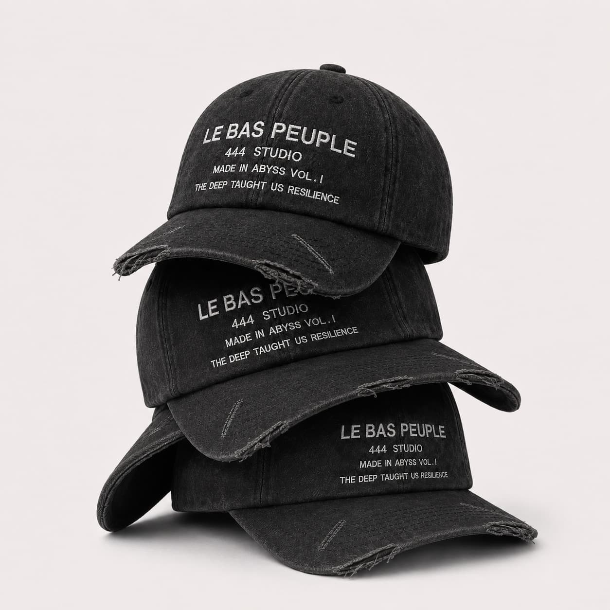 Trois casquettes empilées, montrant le délavé du coton.